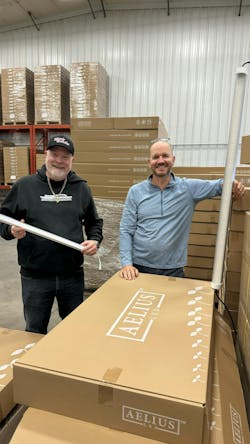 Ryan Kirwan and Landon McDowell at Aelius LED head office holding Aelius 60W and 20W LED tubes.